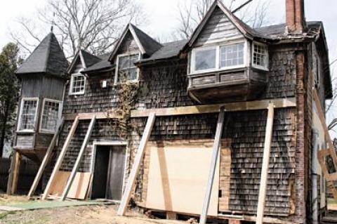 The temporary wooden buttresses in front of the Moran house, pushing up and back against the tilting structure, will give way soon to steel support beams.