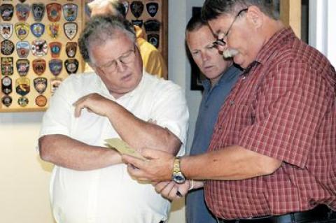 Mayor Brian Gilbride, left, reviewed the numbers that earned him his third term in Tuesday voting. Bruce Stafford, right, did not win in his campaign for trustee. 	Carrie Ann Salvi