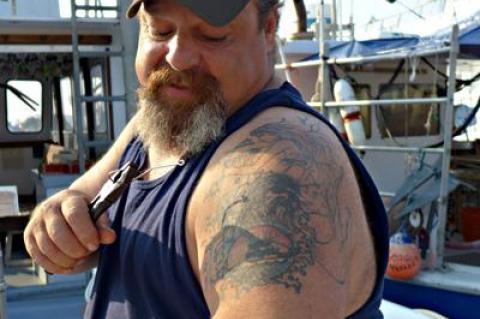 Preparing for a trip Tuesday morning, Rob Aaronson, captain of the charter boat Oh Brother, talked fish and gave a tour of his tattoo that depicts his boat, his daughter, the Montauk Lighthouse, and of course, the sea.