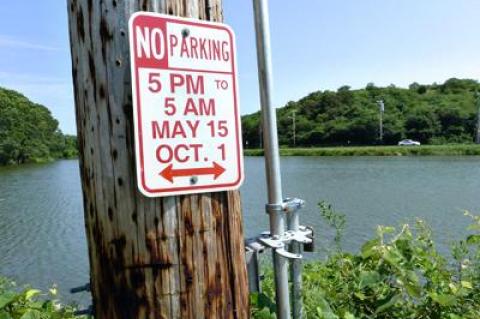 Parking signs like this one on Industrial Road in Montauk have repeatedly gone missing, and police ticketing blizzards have been one result.