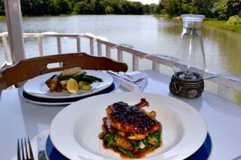 Curry-seasoned chicken and striped bass, with Chase Creek, green and quiet, in the background.