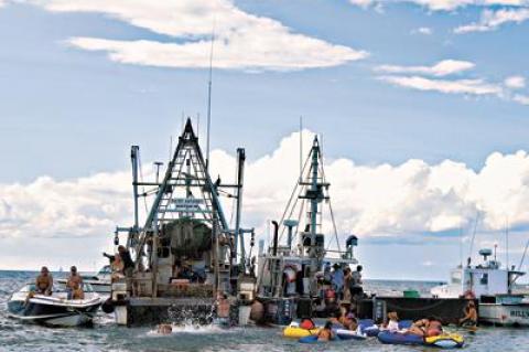 The Anna Mary, anchored in Fort Pond Bay in Montauk Sunday, served as bandstand at a party to celebrate the rescue at sea two weeks ago of John Aldridge, a co-owner of the lobster boat. Lobsters were in copious supply.