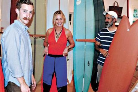 Eric Degenhardt, left, the manager of Pilgrim Surf + Supply, posed with a customer, Susan Jackson, and the store’s owner, Chris Gentile, in the newly renovated shop at Amagansett Square.  	Morgan McGivern