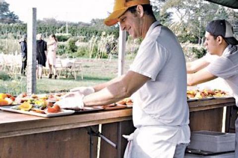 Outstanding in the Field, a California outfit that hosts farm-to-table dinners at outdoor spots around the country, stopped in at the East End Community Organic Farm in East Hampton on Sept. 10, where Jason Weiner, left, of Almond in Bridgehampton was the guest chef.