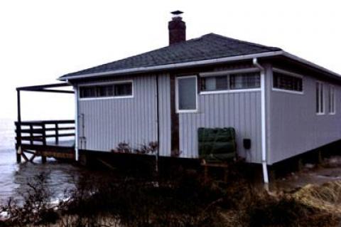 Joshua Young and Christine Lemieux's Mulford Lane house during a storm last winter.