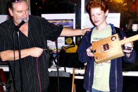 The guitarist Kerry Kearney, left, was so taken by Casey Baron and his cigar-box guitars that he asked the 13-year-old to open his next performance.