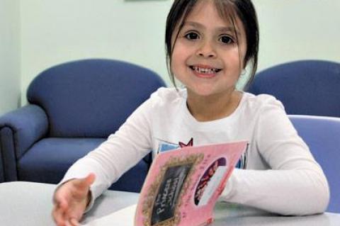 Hannah Salazar, a 5-year-old student at the Child Development Center of the Hamptons, read in the school’s library last week.