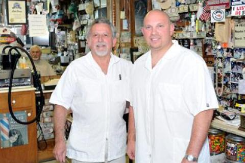 Vinnie Mazzeo, left, and his son and business partner, Nick, will move Vinnie’s Barber Shop from its iconic Main Street location to a new spot in Amagansett Square by New Year’s Day.