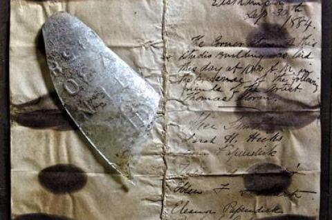 The document commemorating the laying of the cornerstone at the Thomas Moran House, with a shard of the glass jar that contained it.