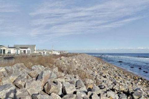 A stone sea wall at the Montauk Shores Condominium in Montauk will be reduced in size and planted with beach grass as part of an agreement between the property association and New York State.