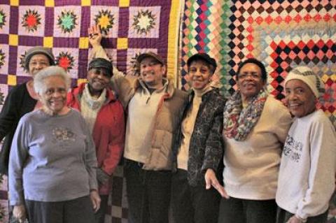 The Eastville Community Historical Society board celebrated the installation of a new quilt show on Saturday in Sag Harbor. From left, Kathy Tucker, Jackie Vaughan, Gloria Primm Brown, Michael Butler, Beryl Banks, Audrey Gaines, and Elinor Fendall stood in front of two quilts made by Patricia Turner, the curator of the show.