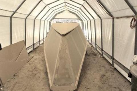 Sheltered under a temporary structure in Amagansett, Dwayne Denton has been building a plywood dory on traditional lines for Dan and Paul Lester, brothers who are commercial fishermen.