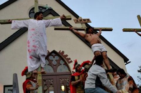 Ricardo Santos, Adrian Sanchez, and Marco Gutama were raised on crosses in the crucifixion scene from a Spanish-language production of the passion play at St. Therese of Lisieux Catholic Church in Montauk Friday.