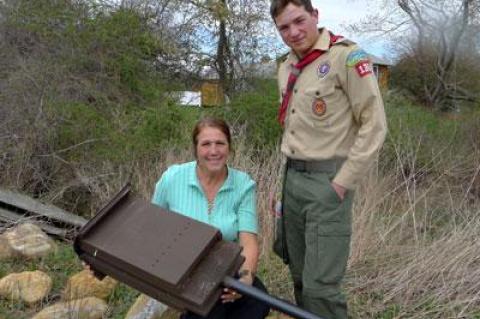 With the help of his fellow Boy Scouts in Troop 136, Richard Malik Atkinson completed the last stage of his Eagle Scout qualifications by building 20 bat houses like the one held by his mother, Dorothy Malik Atkinson.