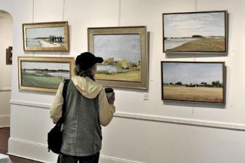 A visitor contemplated a painting at Plein Air Peconic’s exhibition last weekend at Ashawagh Hall in Springs.