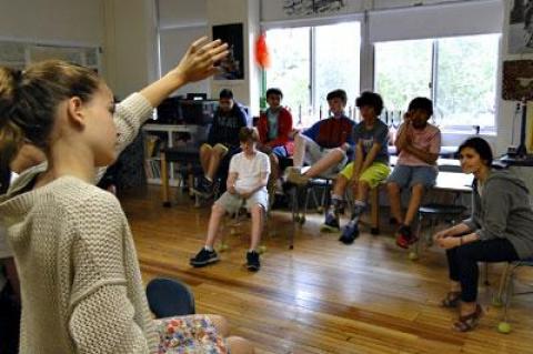 Joanna Howard, seated at right, a teaching artist with Project Hero, oversaw a group session with East Hampton Middle School students on Friday.