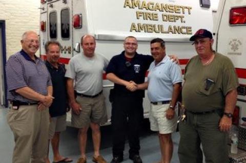 Nick Calace, third from right, a paid paramedic with the Amagansett Fire Department ambulance company, has been recognized for the care he gave a patient having a heart attack on July 9. He posed for a photograph with the fire district commissioners, from left, Jack Emptage, J. Kent Howie, William Vorpahl Jr., Daniel R. Shields II, and Carl Hamilton.