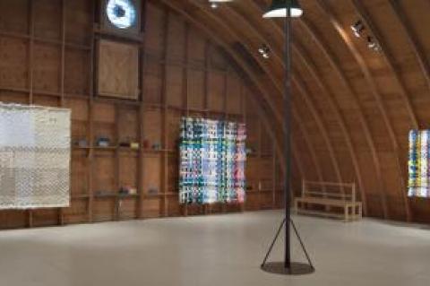 Although Louise Eastman’s woven fiberworks have been mounted on board to hang appropriately in the arched, unfinished rafters of the gallery’s loft, they normally hang without backing.