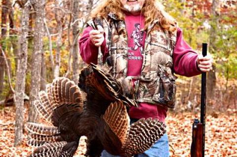 Harvey Bennett, Thanksgiving provider, with wild turkey in hand