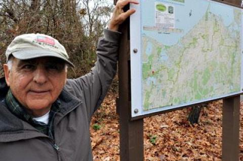 Tony Garro is justifiably proud of the brand-new, colorful, and color-coded hamlet-to-hamlet footpath kiosks, like this one at Trout Pond in Noyac.