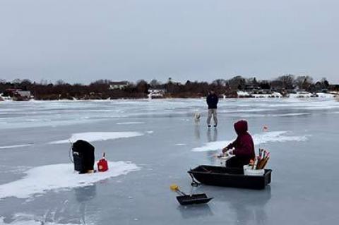 Devon Grisham, below, and Kyle Fagerland, with his dog, Shelby, tried ice fishing on Fort Pond in Montauk on Sunday morning.