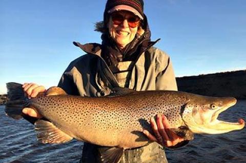 The brown trout Patti Ferrin held proudly, before she released it, weighed 17 pounds.