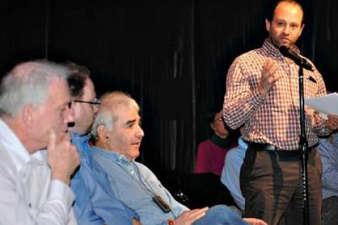 Jonathan Sabin, standing, and his father, Andrew Sabin, seated to his left, said that the town board’s proposed East Hampton Airport regulations are too restrictive.