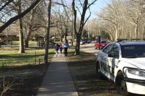 A police officer monitored traffic in front of the Springs School yesterday. The Springs School Board wants to increase parking and improve traffic flow.