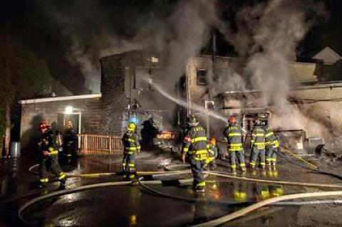 Firefighters worked to control a blaze at the rear of the J. Crew store on Main Street in East Hampton Village on Friday that apparently began when a refrigeration unit at Rowdy Hall restaurant next door malfunctioned.