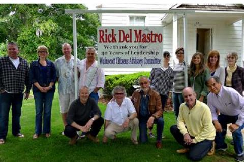 The members of the Wainscott Citizens Advisory Committee erected a sign to thank one of its members, Rick Del Mastro, kneeling at center, for 30 years of service to the committee.