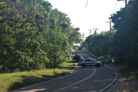 The driver of a Jeep that rolled over after crossing the Cranberry Hole Road bridge in Amagansett on Saturday afternoon was badly injured and later charged with unlicensed driving, driving while intoxicated, and drug possession.