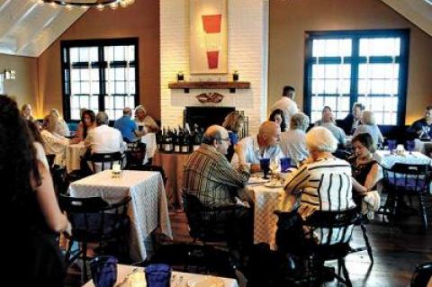 The upstairs dining room at Baron’s Cove in Sag Harbor looks like a yacht club circa 1968.