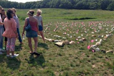 Members of a Montauk group called 12 Women put the finishing touches recently on a stone labyrinth they laid out in the field at Eddie V. Ecker County Park on Navy Road.