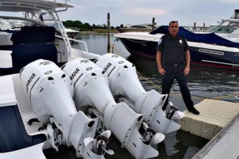 Robert Bori, the Sag Harbor Village harbormaster, straddled a boat at a village dock and an EZ Dock. The boat’s owner got permission for the dock extension because its outboard motors made it too hard to easily reach from the dock.