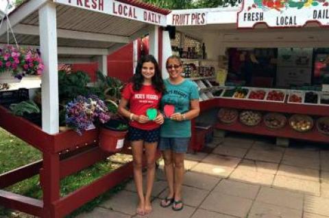 Vicki Littman, right, and her daughter, Maria, with the apples that represent donations earmarked for the East Hampton Food Pantry.