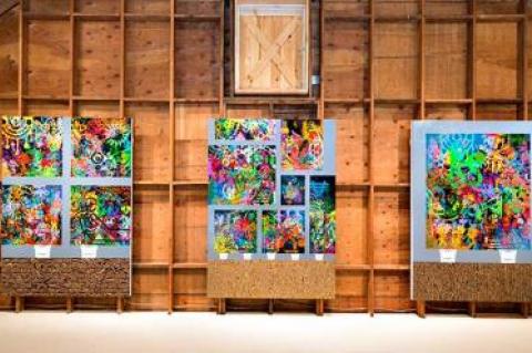 Ryan McGinness’s paintings line the back wall of the gallery loft.