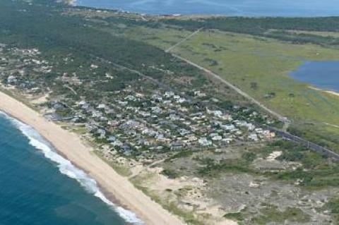 A resident of Dolphin Drive, a street on a narrow portion of Napeague, has sued East Hampton Town to prevent cars from parking on his road, which he says will lead to degradation of dunes and place his neighborhood in danger of flooding.