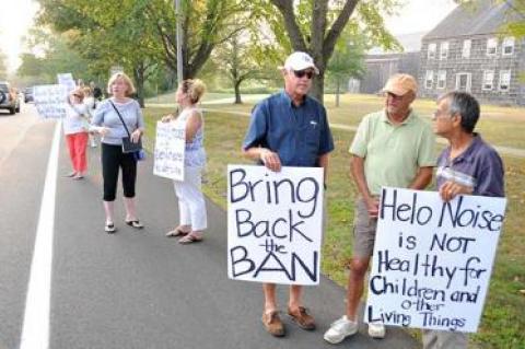 After picketing outside Town Hall last Thursday night, residents affected by aircraft noise told the town board an overnight curfew this summer gave limited relief and urged continued efforts.