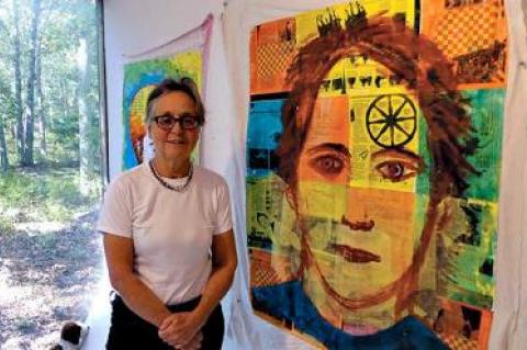 Christina Schlesinger was framed by the view of the woods behind her Springs studio while she showed her new mixed-media portraits.