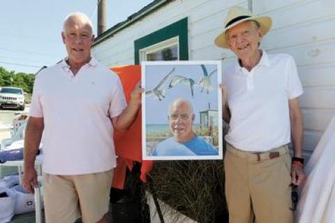 Perry Duryea III received a painting of himself from Paul Davis, right, at a Fighting Chance lunch in Montauk on Friday.