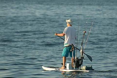 A calm ocean made for ideal conditions as a man on a well-outfitted stand-up paddleboard headed out for some fishing at Atlantic Avenue Beach in Amagansett on Saturday morning.