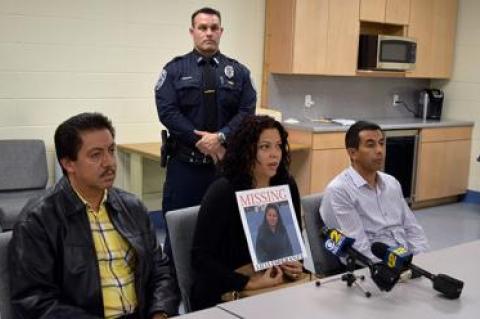 Maria Duchi held a poster with her aunt Lilia Aucapina’s photograph. Ms. Duchi spoke at a Southampton press conference on Oct. 21 about Ms. Aucapina’s disappearance. With her were Ms. Aucapina’s brother, Victor Parra, left, and Carlos Parra, right.