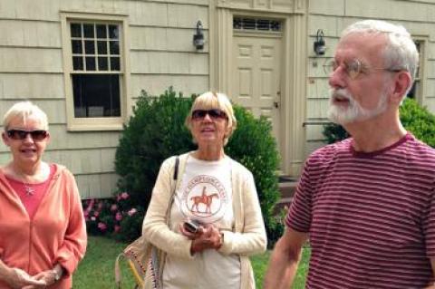 Richard Barons, right, led a 2014 East Hampton Historical Society walking tour that included a stop at the historic Village Hall building.