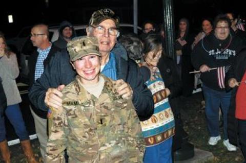 A crowd gathered at Hook Mill in East Hampton on Friday to welcome home Army Reserve First Lt. Elizabeth Mamay from a nine-month deployment. Among the well wishers was her grandfather John McNally.