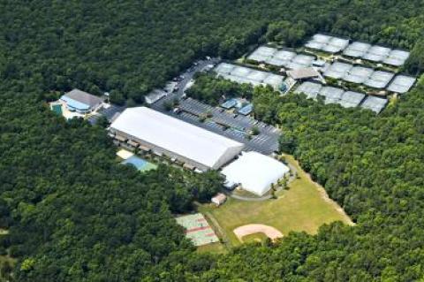 The cleared land to the lower right of the photo, including the present “bubble,” which is to be moved to seasonally cover the four courts to the left of the outdoor clubhouse, is the area under discussion with the East Hampton Town Planning Board.