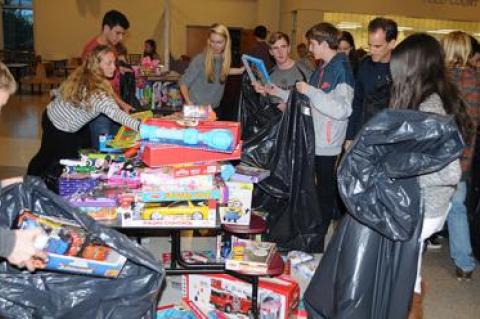 In the East Hampton High School cafeteria on Monday, members of the school’s Key Club sorted some 1,000 toys collected for local children in need by the Kiwanis Club of East Hampton Toys for Tots program.