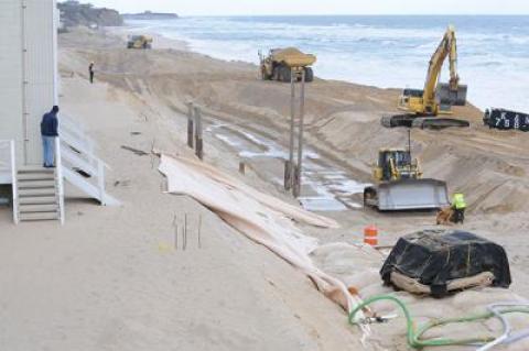 Contractors for the Army Corps of Engineers are moving down the Montauk beach to construct a mostly buried wall of sandbags. The first section, at the western end of the downtown shore, has been completed.  	Morgan McGivern Contractors for the Army Corps of Engineers are moving down the Montauk beach to construct a mostly buried wall of sandbags. The first section, at the western end of the downtown shore, has been completed.