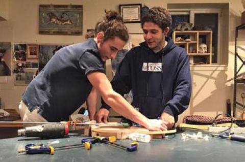 Yanni Giannakopoulos, left, and Malik Basnight, right, have taken on complicated woodworking projects at the Ross School. Yanni is replicating a famous guitar, Malik is building four artistic chairs, and the two friends have been helping each other along the way.