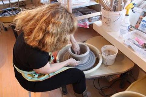 Eve Behar, a professional ceramic artist who is the president of the Clay Art Guild of the Hamptons, digs deep and gets her hands full of clay at the potter’s wheel, throwing what would eventually become a wide-mouthed bowl.