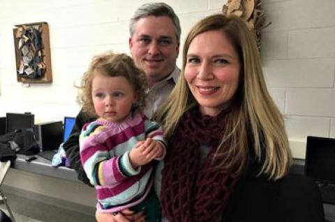 Beth Doyle, right, the principal at the John M. Marshall Elementary School, was granted tenure on Tuesday night. There with her were her husband, Michael Guinan, an assistant principal at Pierson High School, and their daughter, Olive.